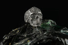 Mexican sugar skull sterling silver ring with black stones, angled view