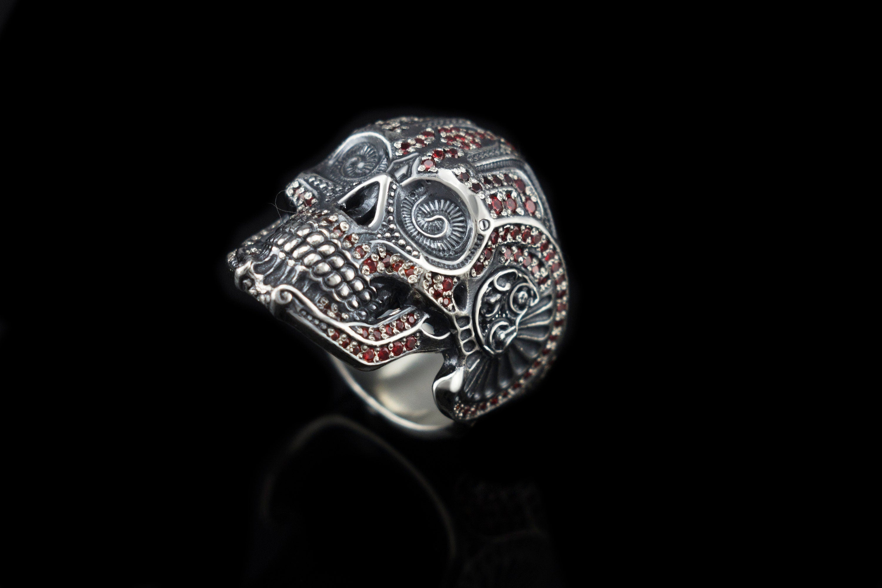 Close-up of the ornate calavera skull face on the silver ring