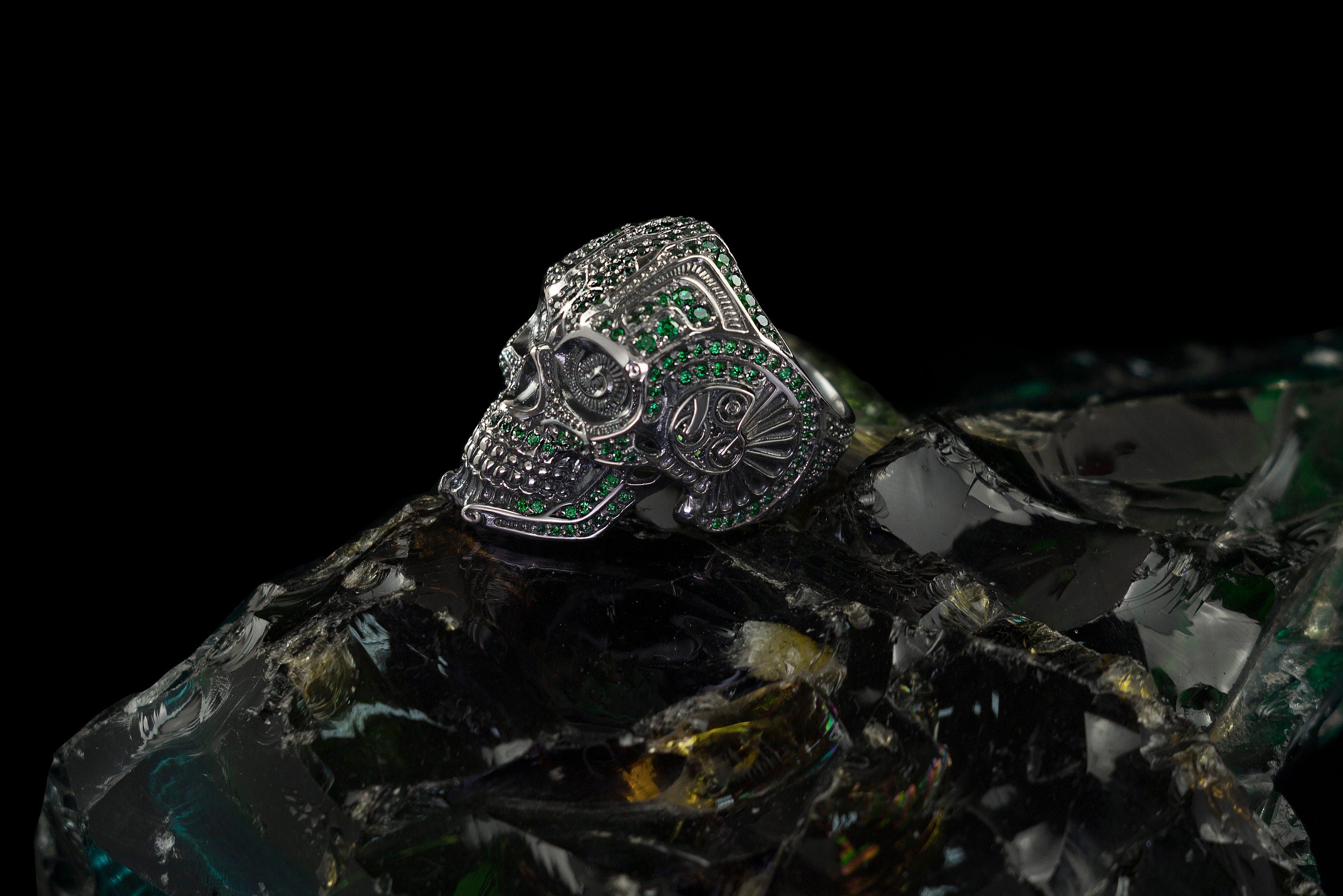Green stone calavera ring, angled view of the ornate skull