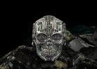 Mexican sugar skull sterling silver ring with green stones on black