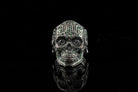 Sugar skull silver ring with green stones, front view