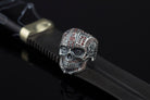 Sugar skull silver ring on a black leather strap, side view