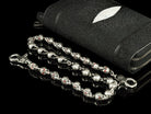 Two strands of the Mitchell skull wallet chain on black leather