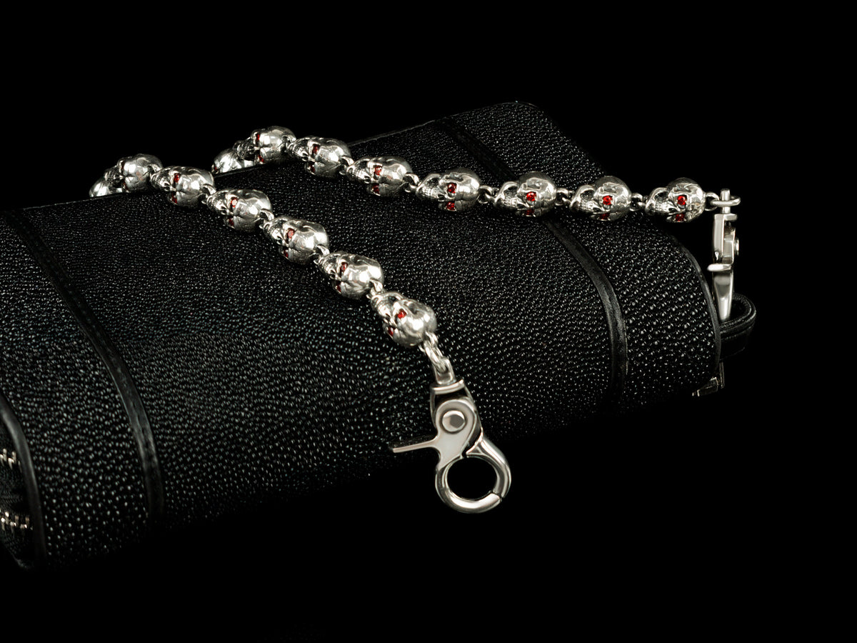 Mitchell skull wallet chain lying on a black textured wallet