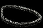 Mokorr heavy sterling silver chain for men laid in an oval on a black background
