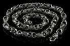 Mokorr sterling silver chain coiled in a spiral, showing the clasp and ornate links