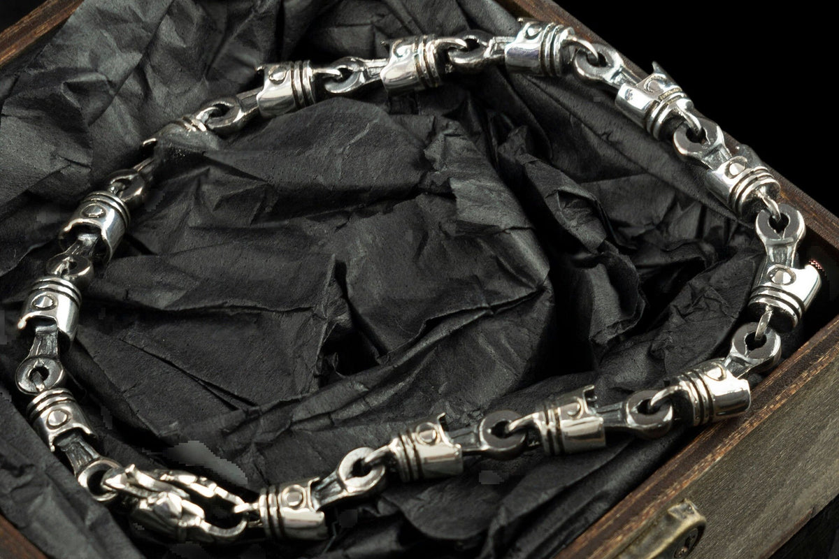 Detail of sterling silver piston links and clasp in an open gift box
