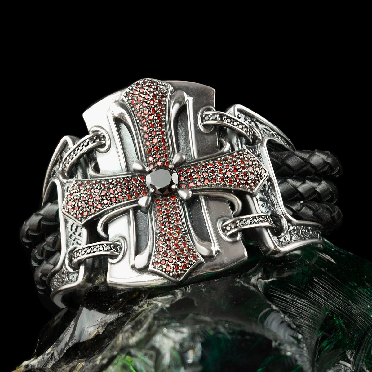 Close-up of the pave cross and center stone resting on a green stone