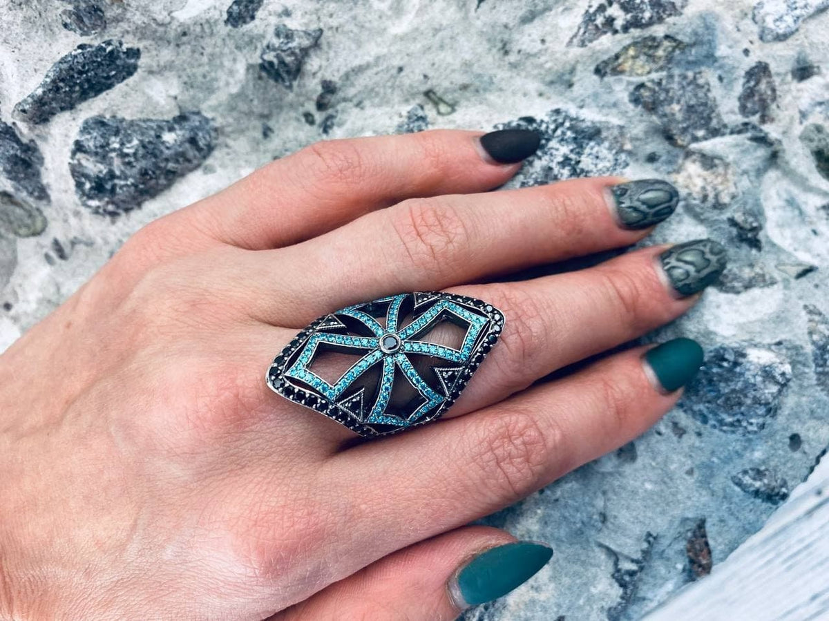 Women's gothic ring with cubic zirconia cross pattern worn on the index finger