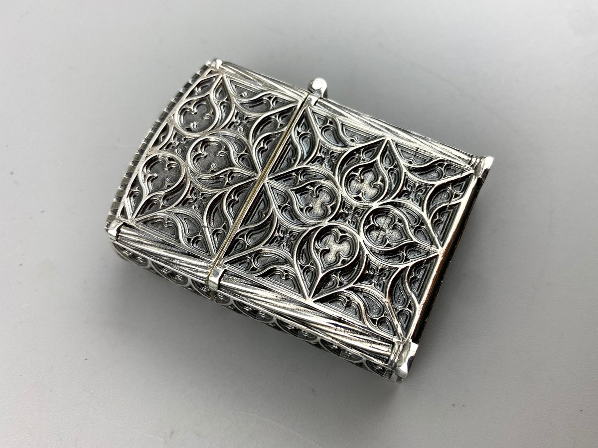 Relic silver lighter case, back view with pointed arch pattern