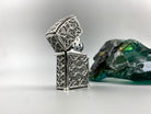 Relic silver lighter case with the lid open, gothic tracery on every side
