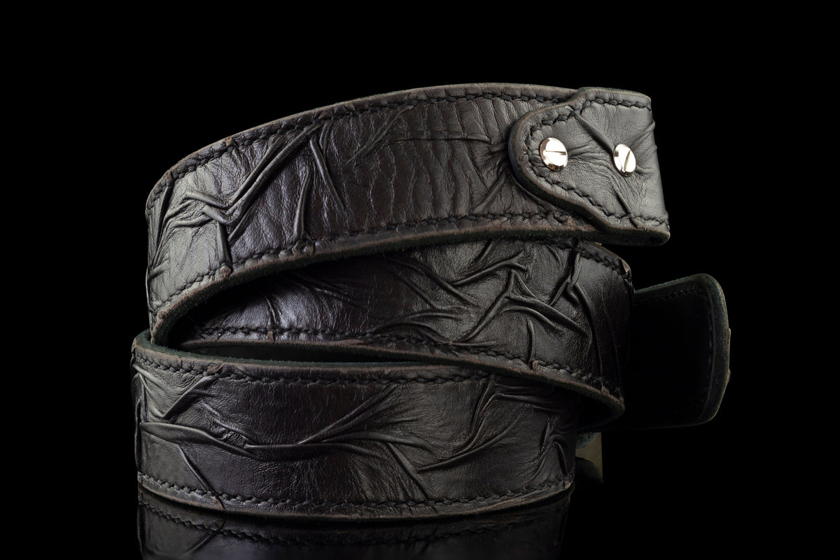 Close-up of the distressed rock texture and edge stitching on the leather strap