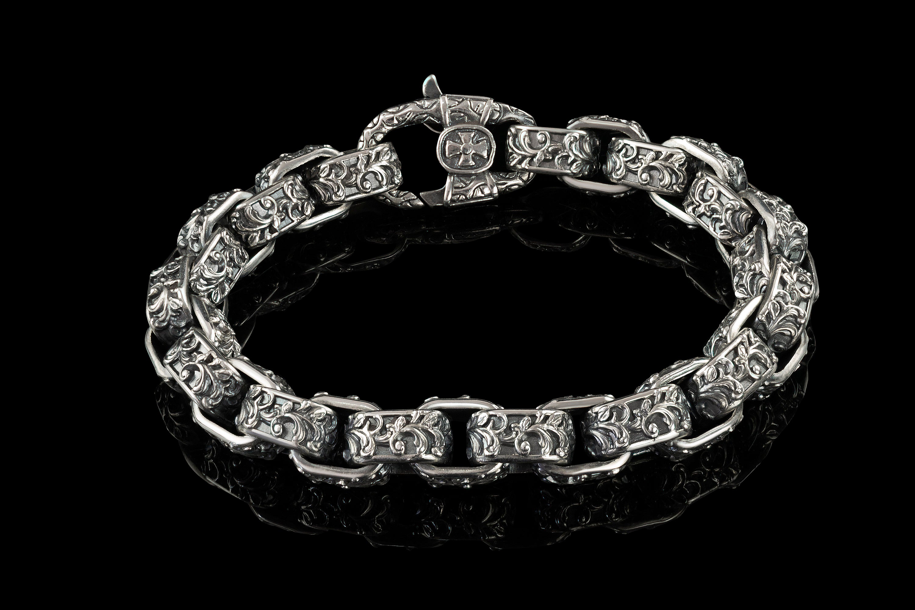Heavy men's sterling silver bracelet with oxidized high-relief ornament on every link