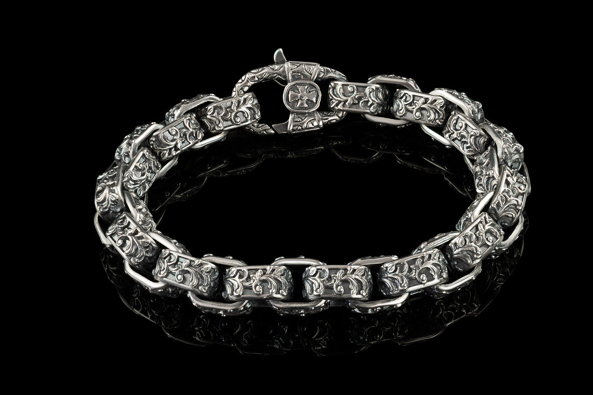 Heavy men's sterling silver bracelet with oxidized high-relief ornament on every link