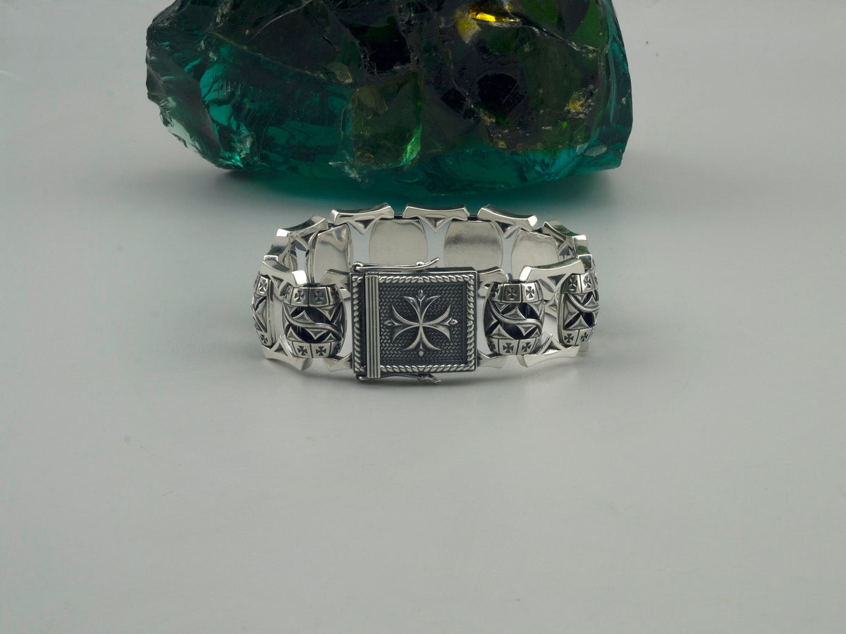 Royal Blessing silver biker bracelet lying flat with Maltese cross clasp on top