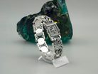 Royal Blessing bracelet on a stand, polished inner side of the links