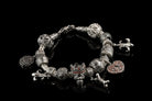 Crowned skull charm bead styled on a silver charm bracelet with other beads (bracelet not included)