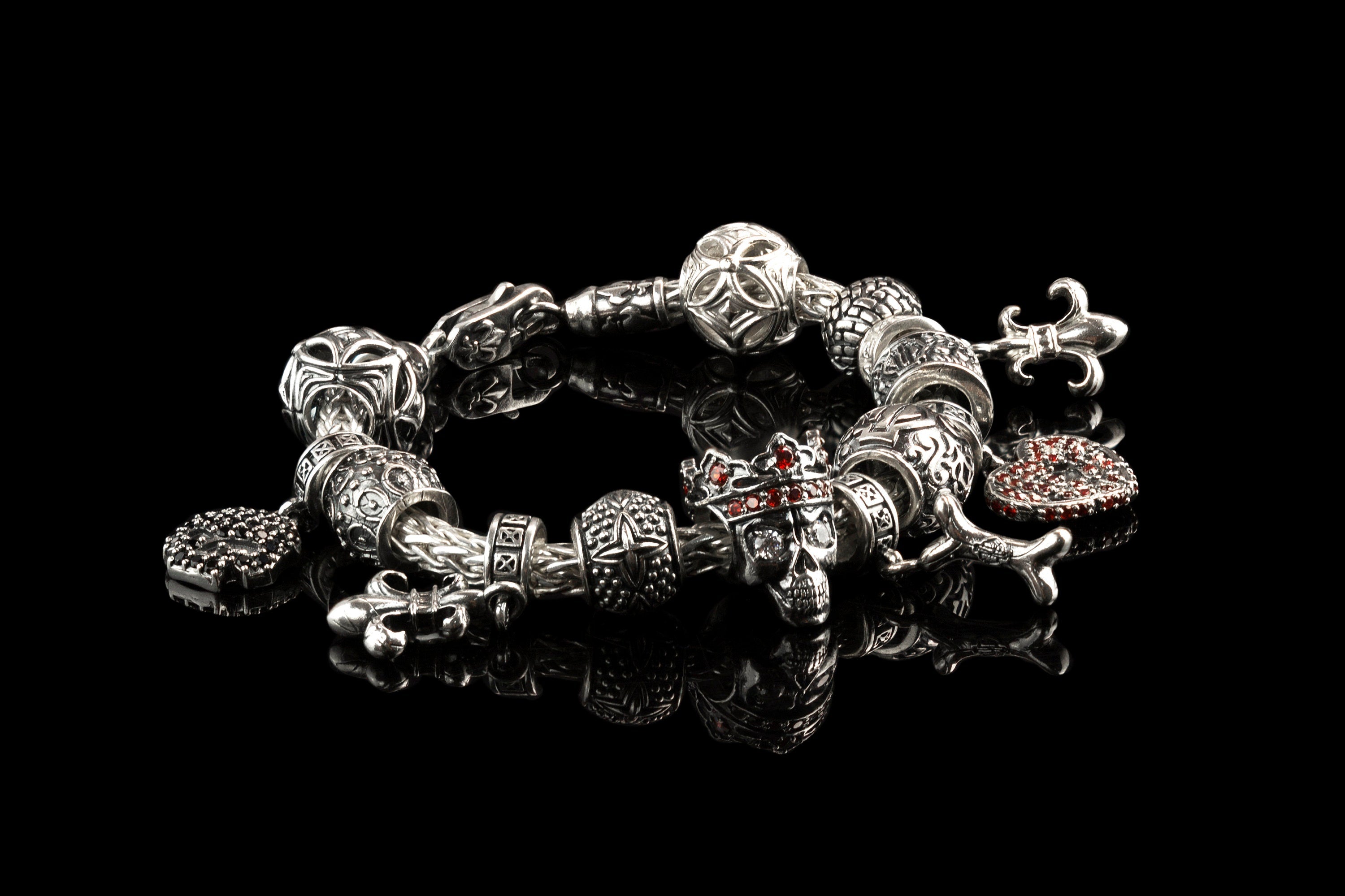 Silver charm bracelet with Santa Muerte crowned skull bead among other charms (bracelet not included)