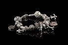 Silver charm bracelet with Santa Muerte crowned skull bead among other charms (bracelet not included)