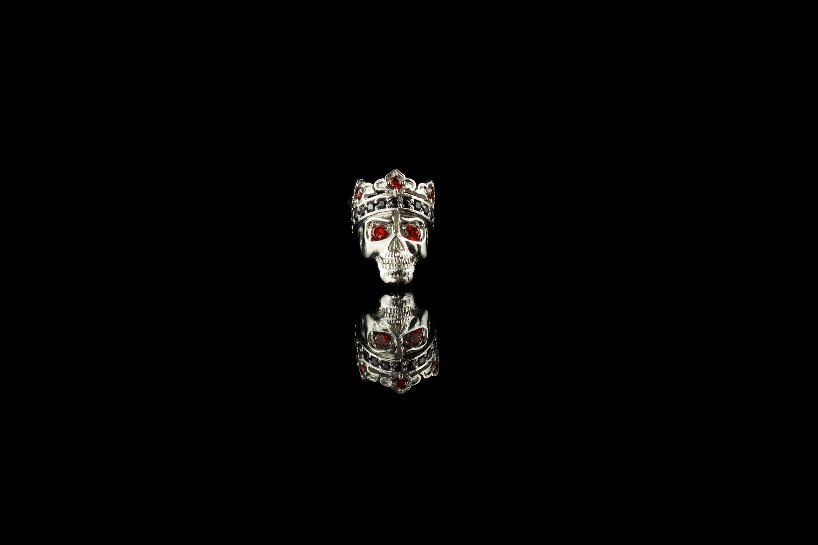 Santa Muerte crowned skull charm bead in sterling silver with red cubic zirconia eyes, front view