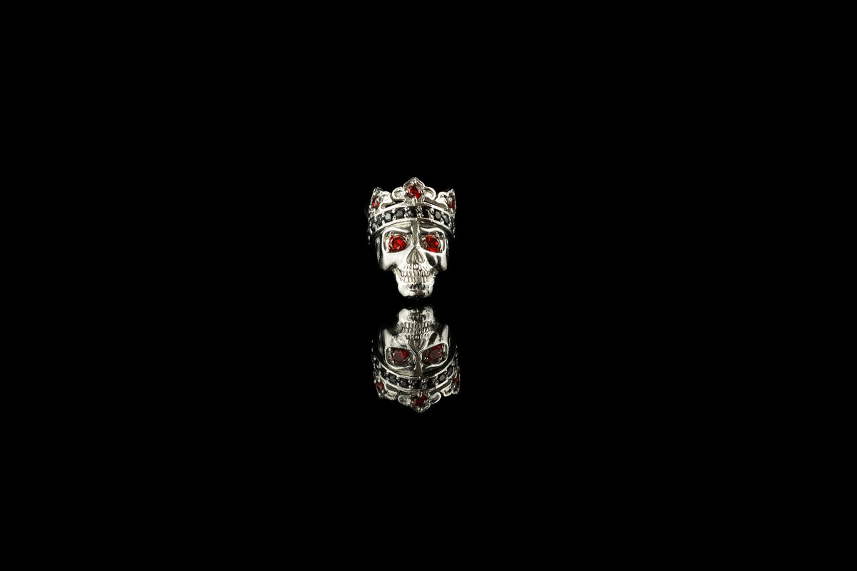 Santa Muerte crowned skull charm bead in sterling silver with red cubic zirconia eyes, front view