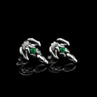Silver scorpion stud earrings with green cubic zirconia