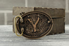 Back of the brass and silver belt buckle with the belt attachment
