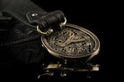 Silver and brass skull belt buckle, side view