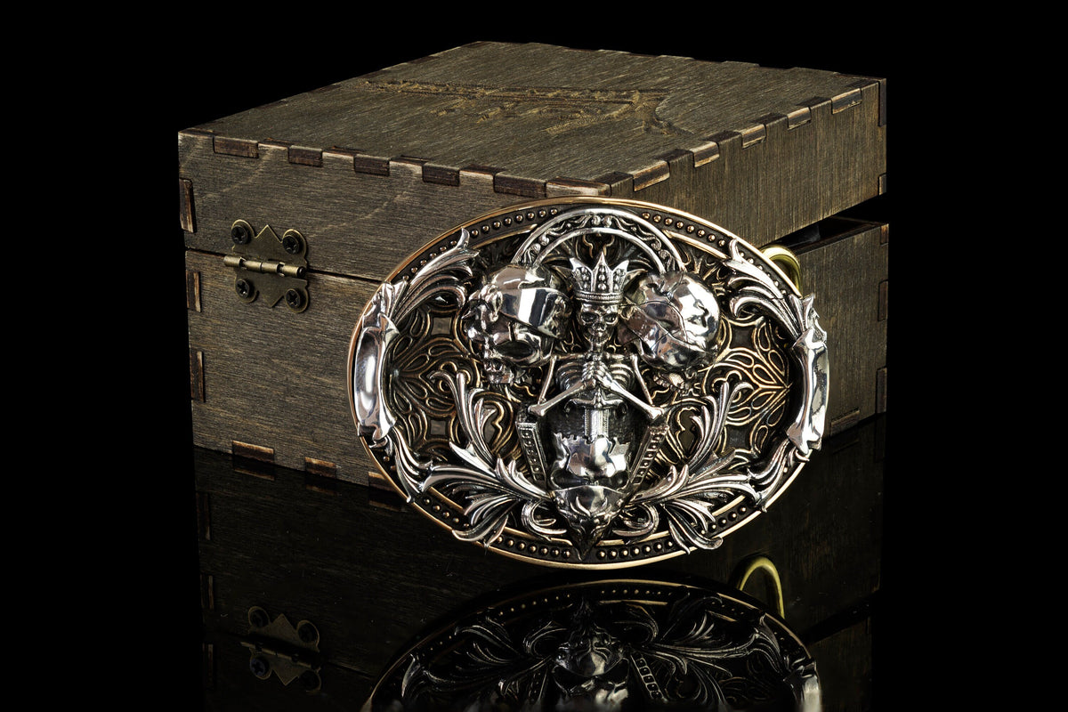 See No Evil Hear No Evil Speak No Evil skull buckle on a wooden box