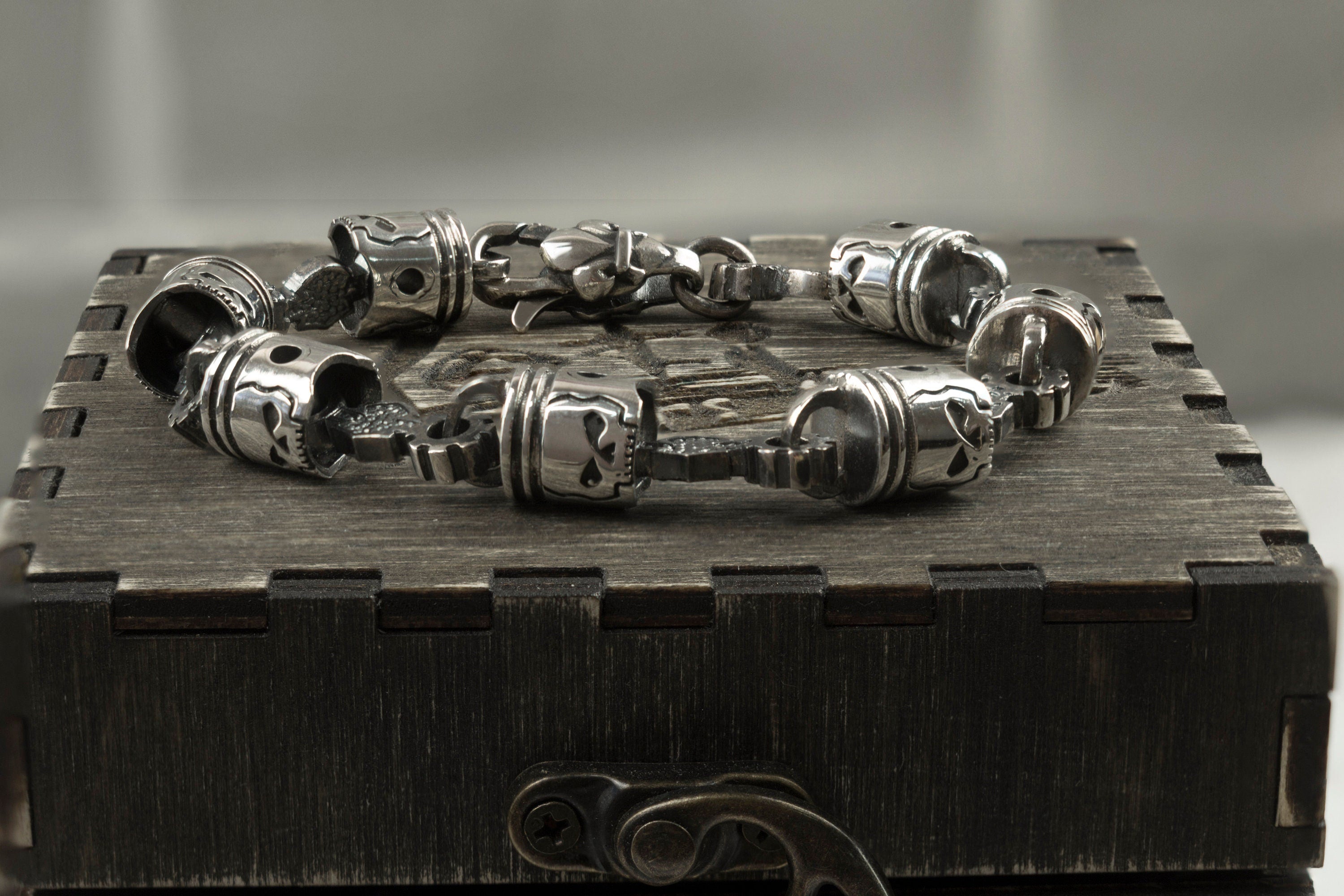 Skull piston bracelet across the lid of a wooden gift box
