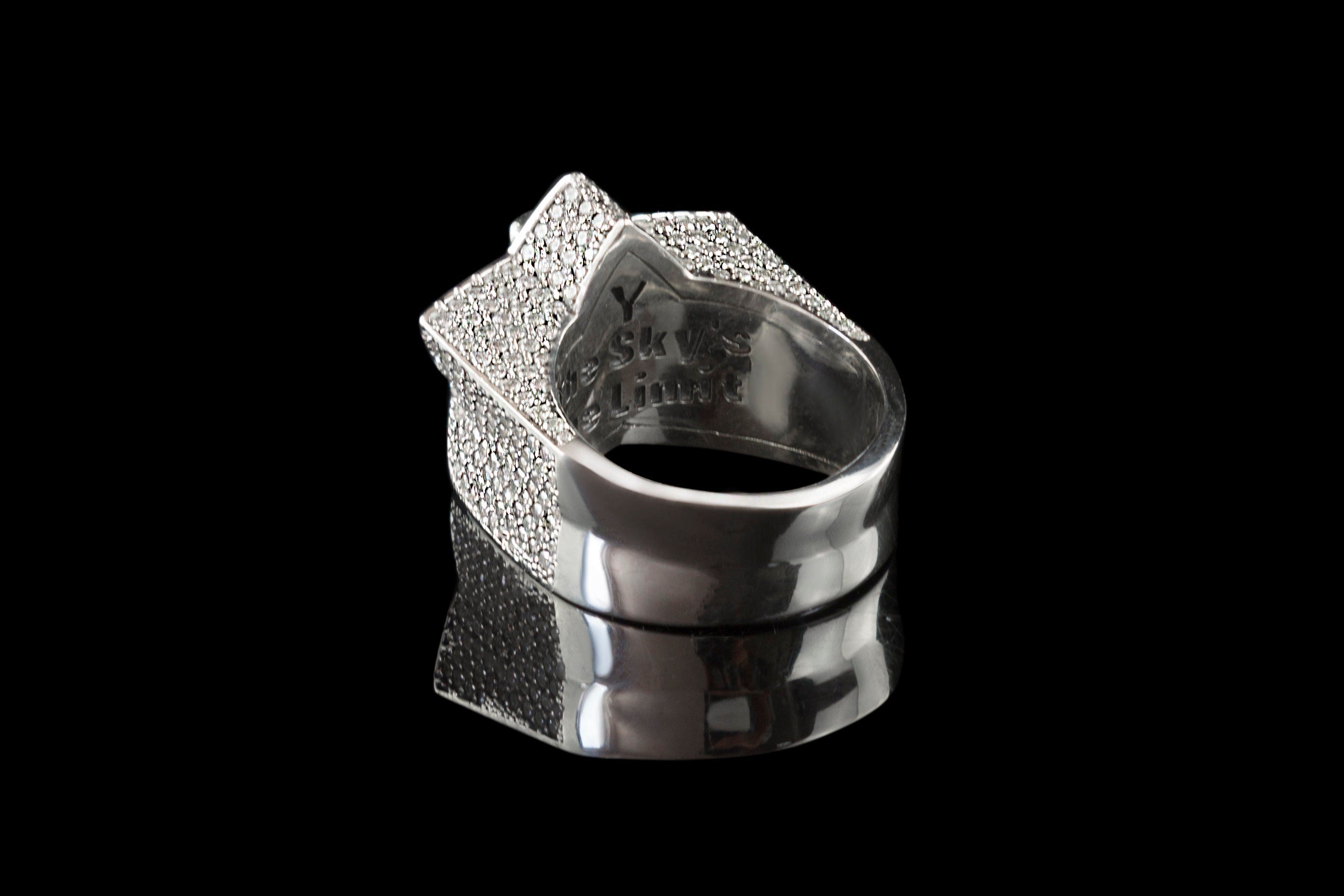 Side view of the clear CZ star skull ring and silver band