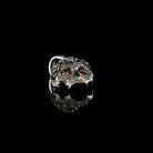 Tiny Frida sterling silver floral skull pendant with red stone eyes, front