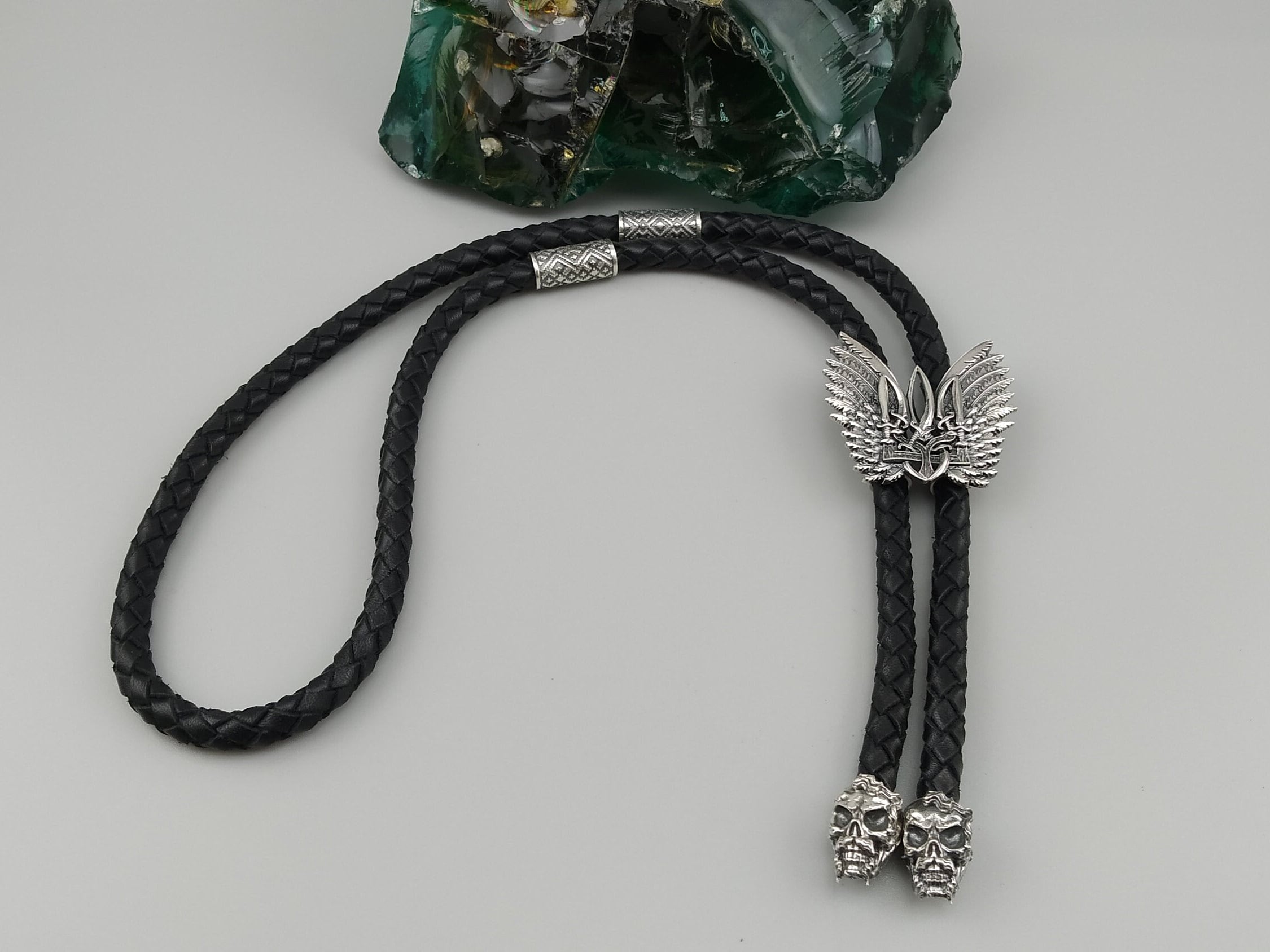 Winged Tryzub sterling silver bolo tie on braided black leather cord with skull tips