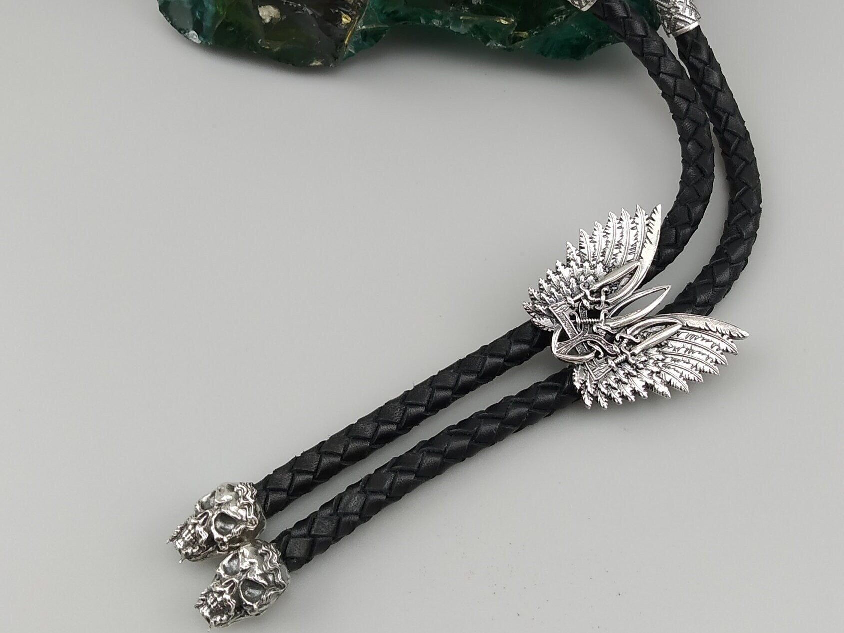 Detail of the winged sterling silver Tryzub slide on black braided leather