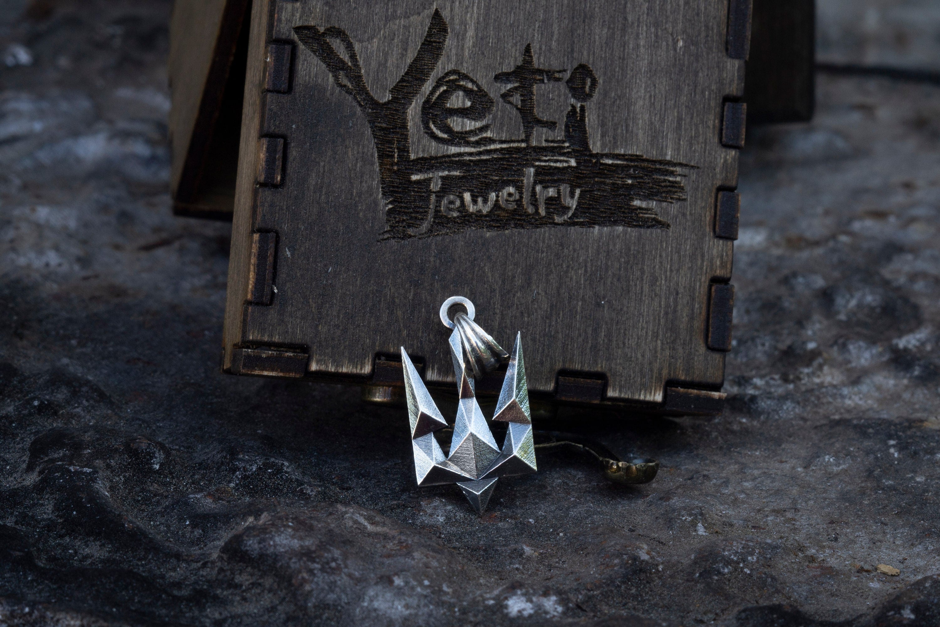 Ukrainian trident pendant lying on a wooden box