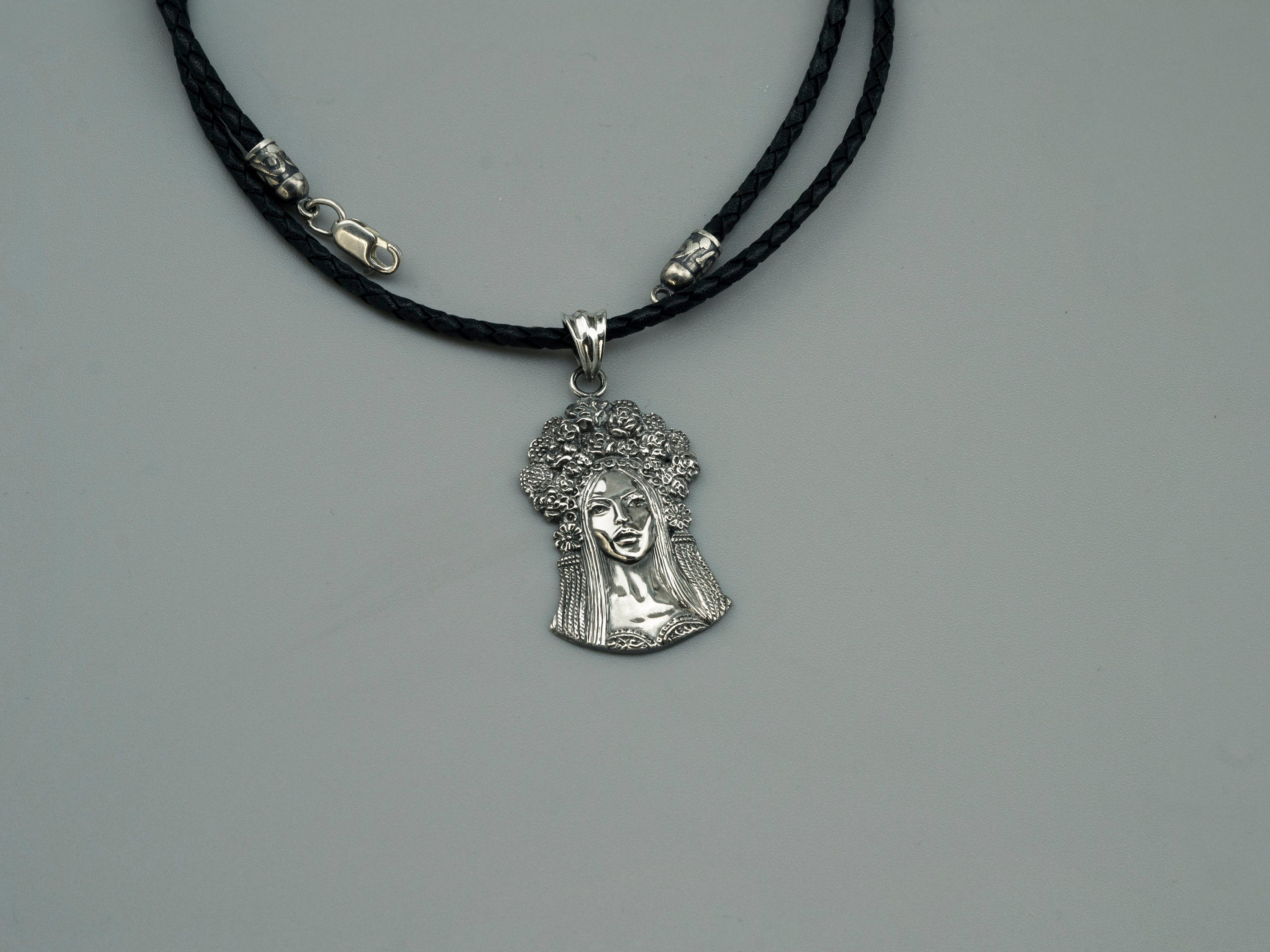 Sterling silver pendant of a Ukrainian woman with a floral wreath, detail 3