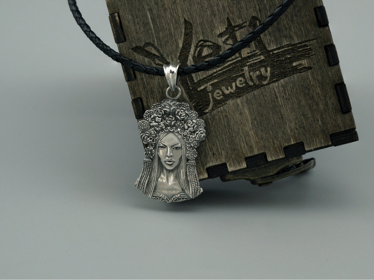 Sterling silver pendant of a Ukrainian woman with a floral wreath, on cord box