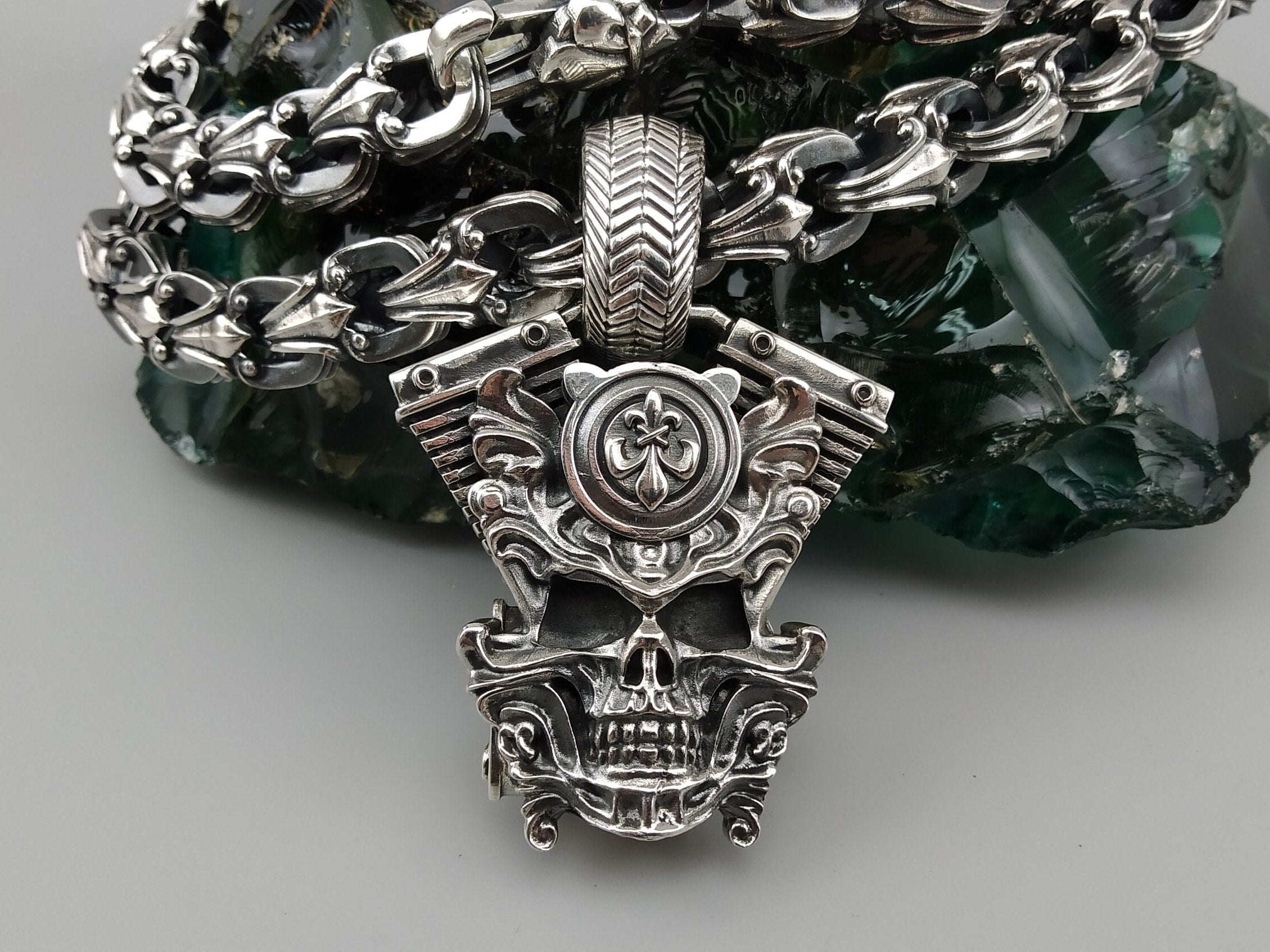 Vigor V-twin pendant hanging on a chain, full front view