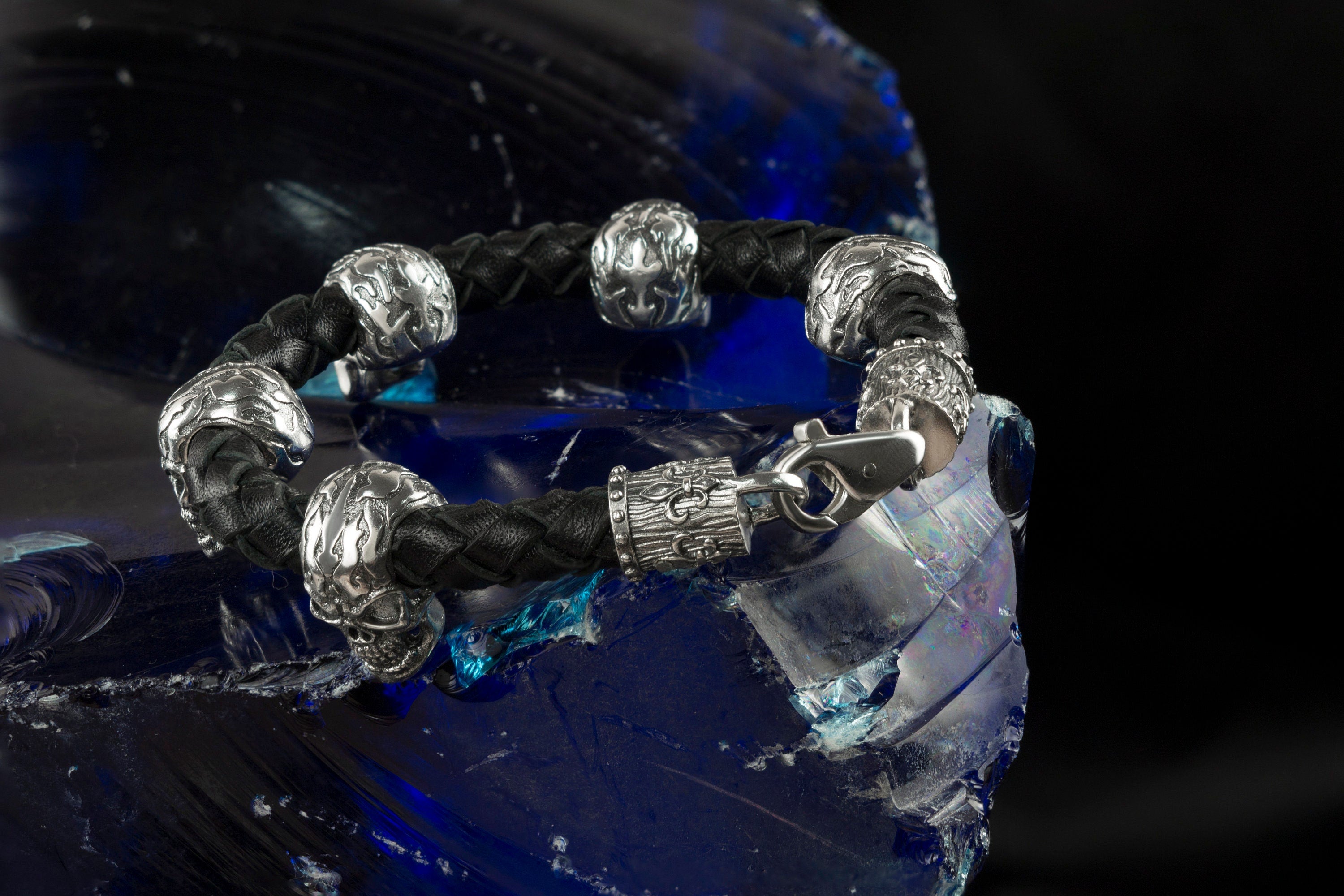 Close-up of silver skulls and end caps on the Wild leather bracelet