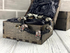Wild bracelet red-eyed skulls on the edge of a wooden box