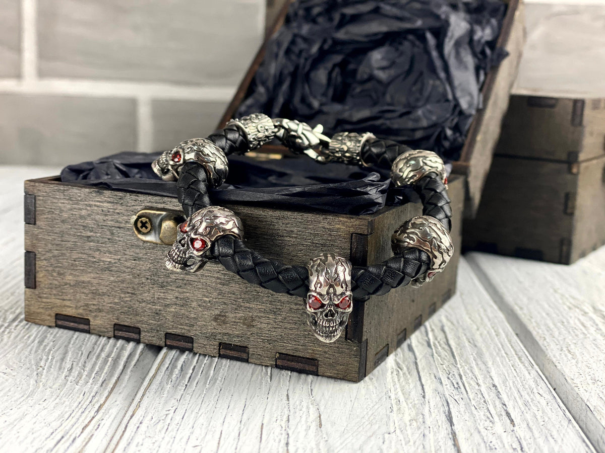 Wild bracelet red-eyed skulls on the edge of a wooden box
