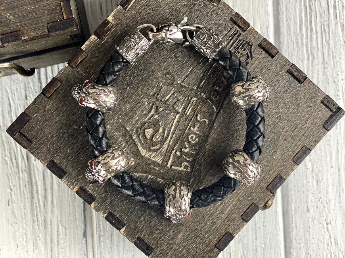 Wild leather skull bracelet coiled on a wooden box lid
