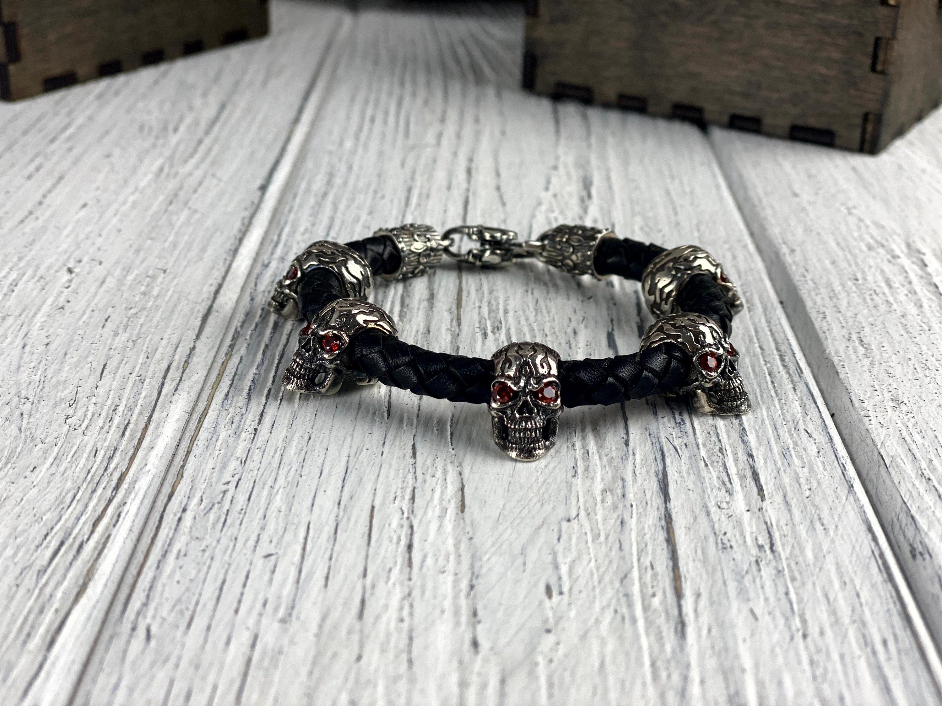 Wild skull leather bracelet lying on a white wooden surface