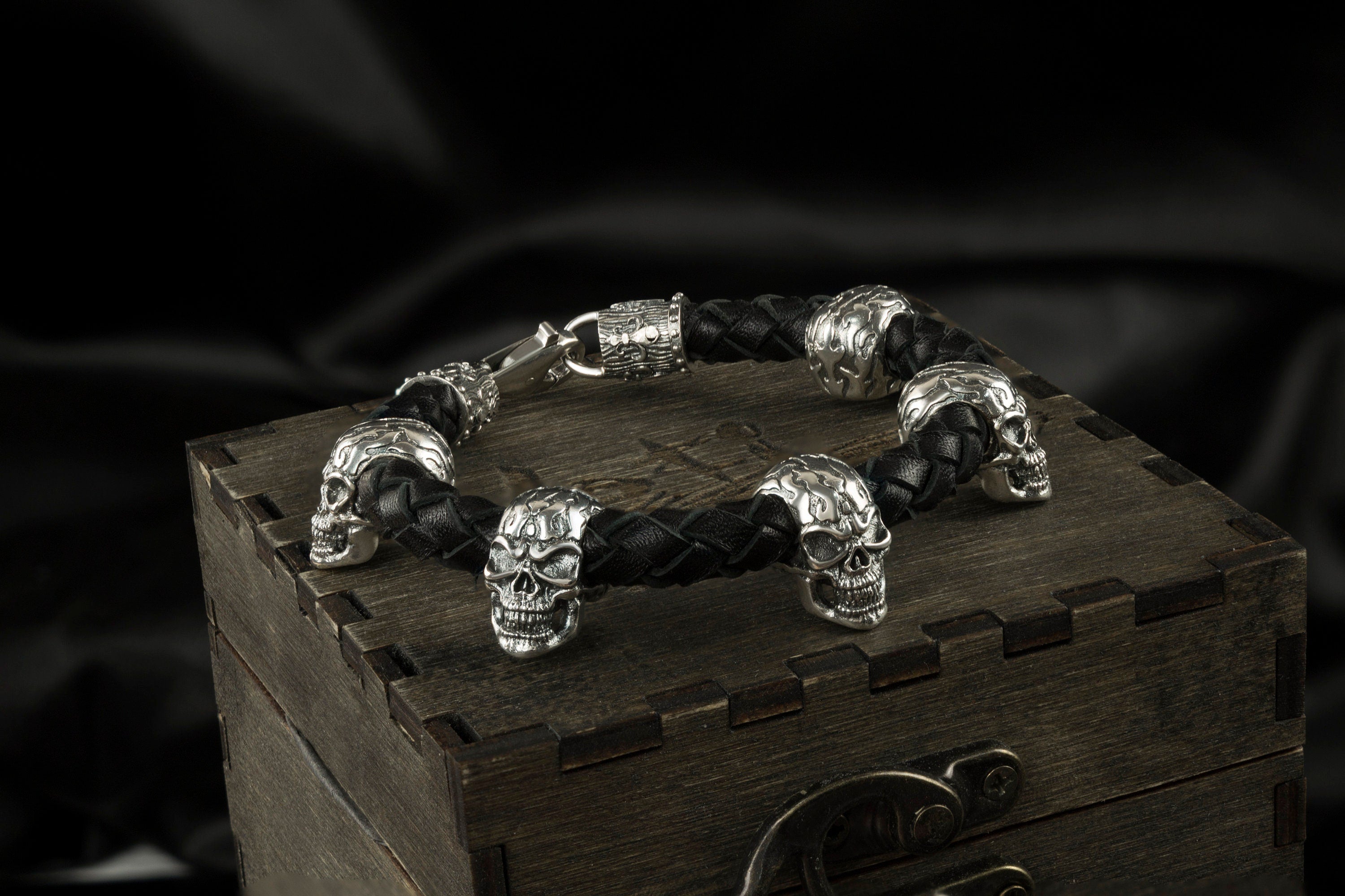 Wild skull leather bracelet lying on a wooden gift box