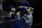 Wild bracelet with sculpted sterling silver skulls on braided black leather