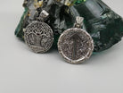Yggdrasil pendant next to a round Tiwaz rune pendant in sterling silver