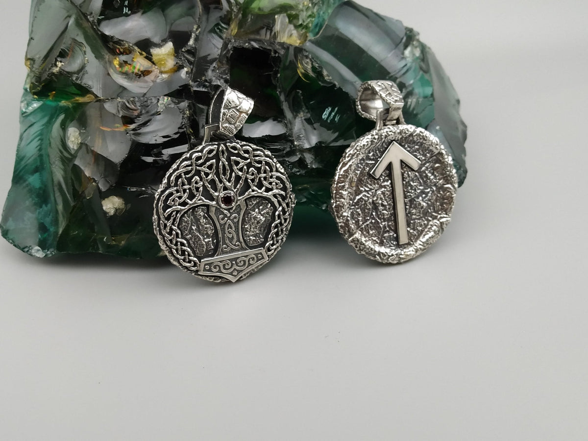 Yggdrasil pendant and Tiwaz rune pendant side by side, front view