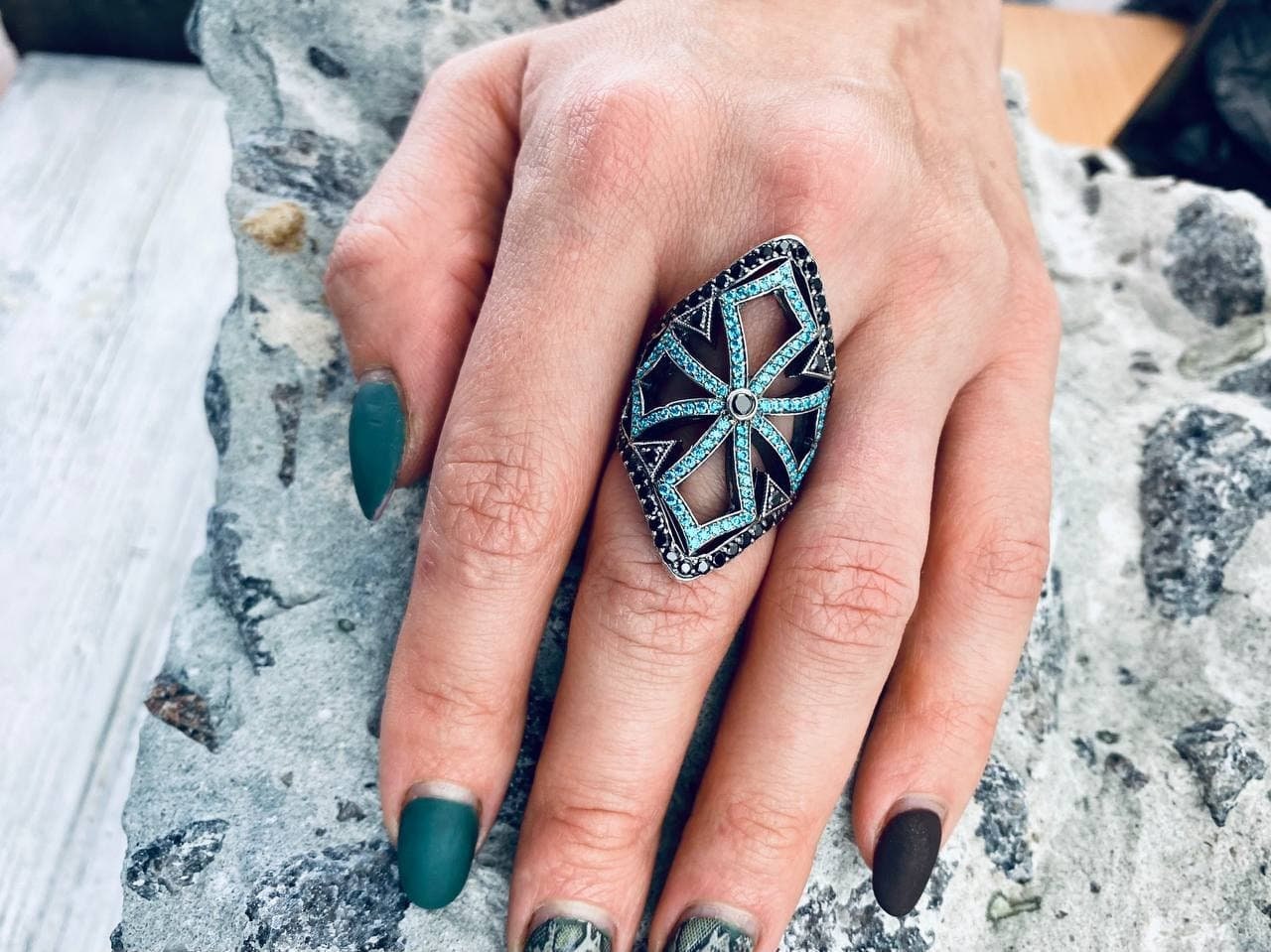 Long sterling silver armor ring covering the finger, side view on hand